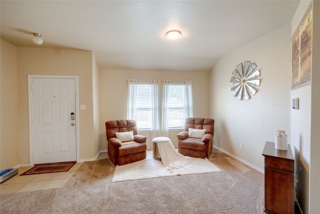 sitting room with light colored carpet and lofted ceiling