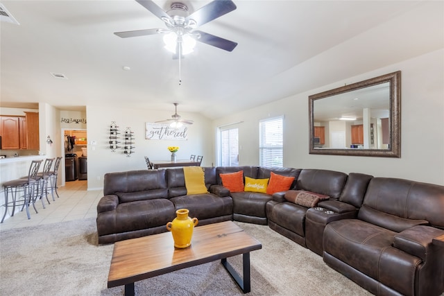 living room featuring light tile patterned floors, vaulted ceiling, and ceiling fan