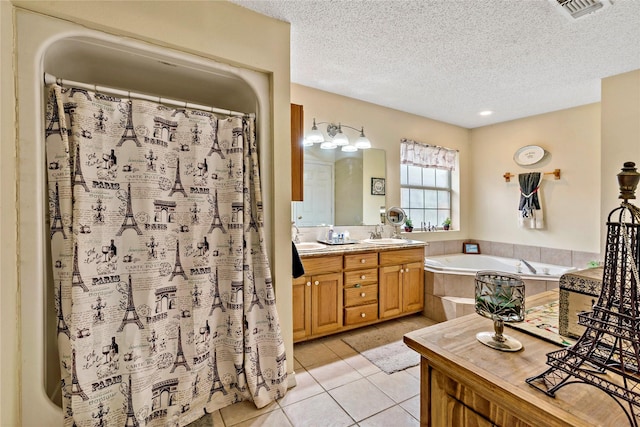 bathroom with tile patterned floors, vanity, a textured ceiling, and independent shower and bath