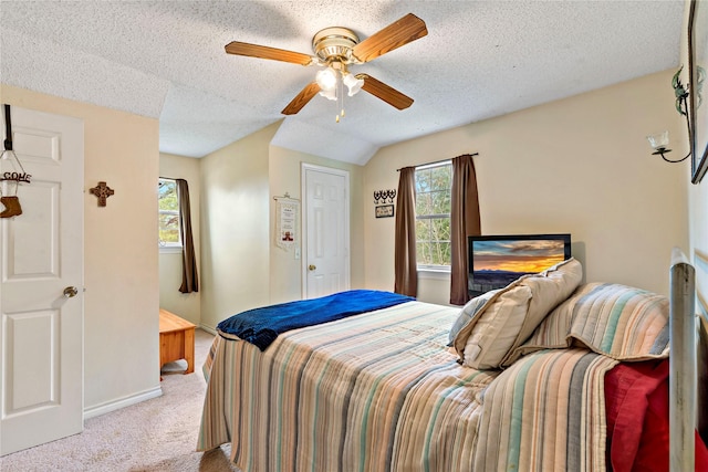 bedroom with a textured ceiling, light colored carpet, and ceiling fan