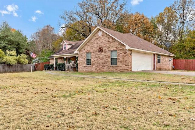 exterior space with covered porch, a garage, and a front lawn