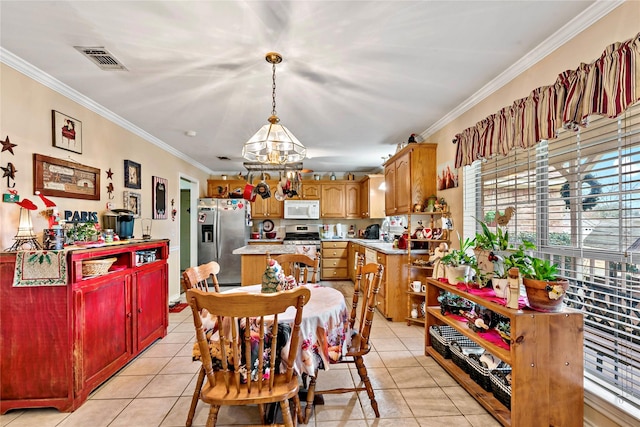 dining area with sink, ornamental molding, and light tile patterned flooring