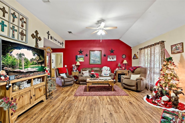 living room featuring ceiling fan, hardwood / wood-style floors, and lofted ceiling