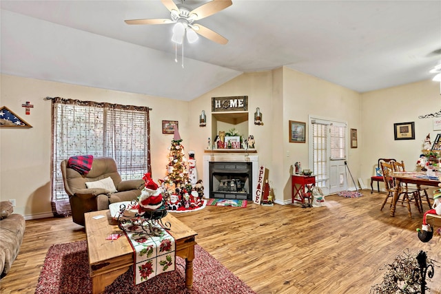 living room featuring wood-type flooring, ceiling fan, and lofted ceiling