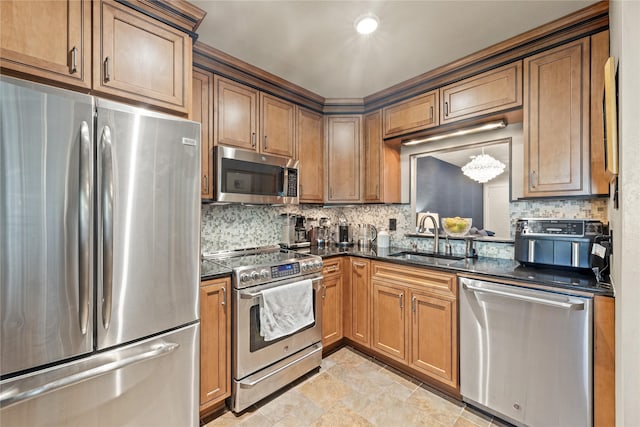 kitchen with backsplash, dark stone countertops, sink, and appliances with stainless steel finishes