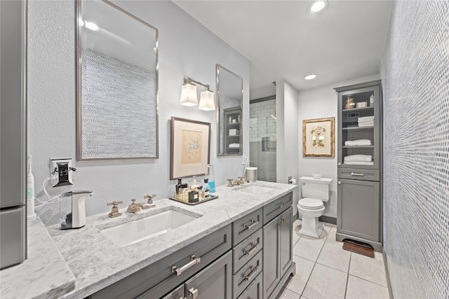 bathroom featuring tile patterned floors, a shower with door, vanity, and toilet