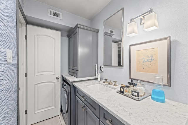 bathroom with vanity and washer / clothes dryer