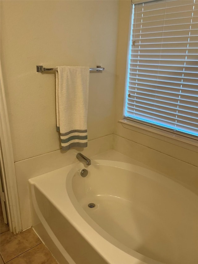 bathroom featuring tile patterned flooring and a bathtub