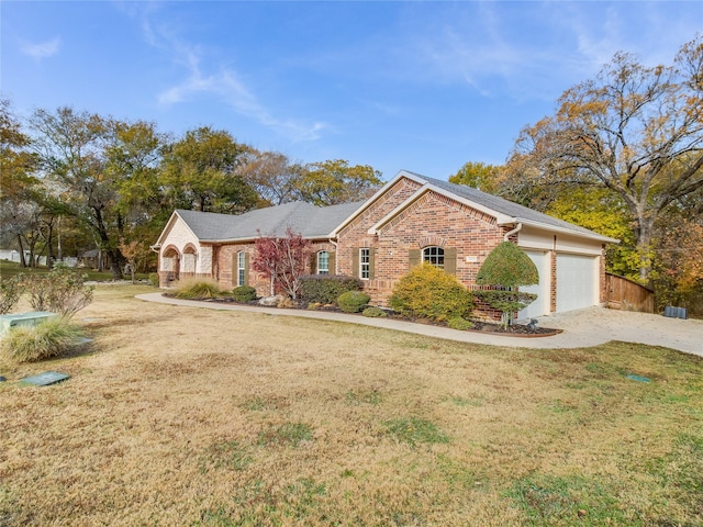 view of front of house featuring a garage and a front lawn