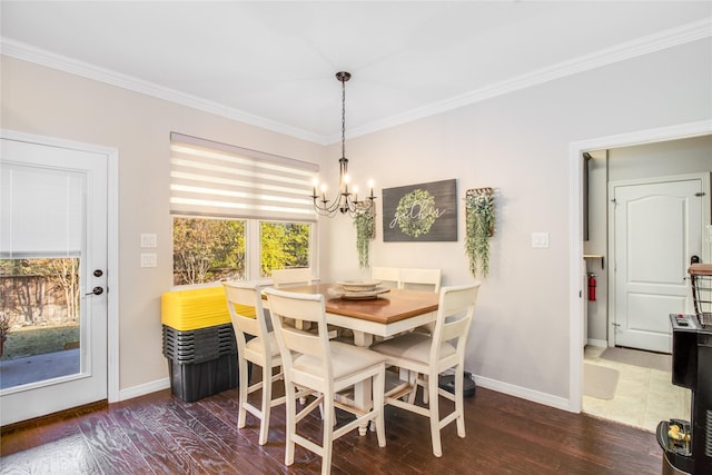 dining area with a notable chandelier, dark hardwood / wood-style flooring, and ornamental molding