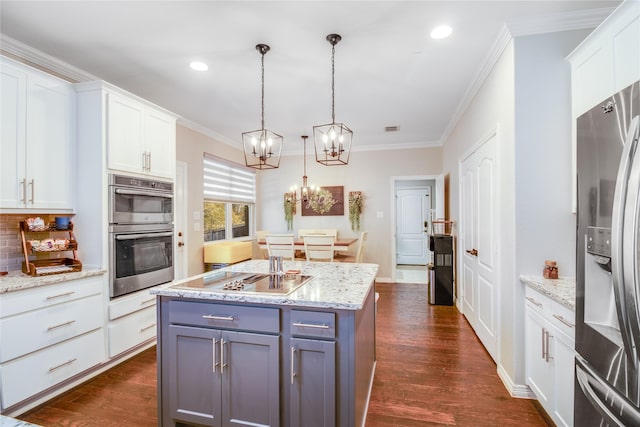 kitchen featuring pendant lighting, white cabinets, decorative backsplash, dark hardwood / wood-style flooring, and stainless steel appliances