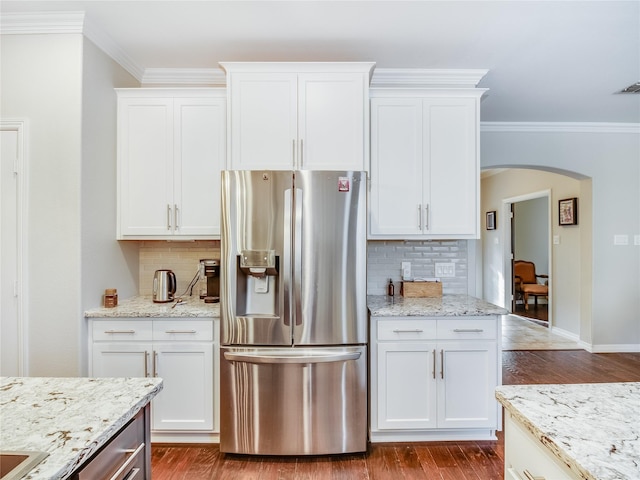 kitchen with wood-type flooring, white cabinetry, and stainless steel refrigerator with ice dispenser