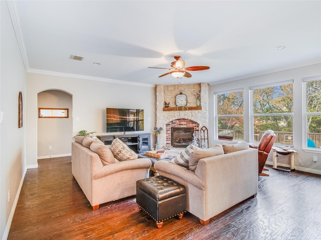 living room featuring crown molding, plenty of natural light, and dark wood-type flooring