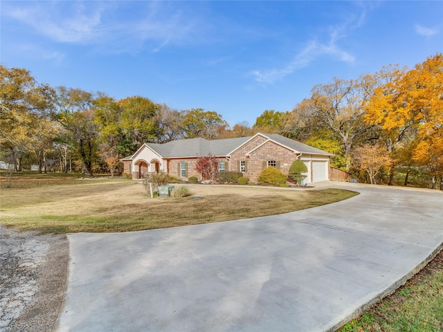 single story home featuring a garage and a front lawn