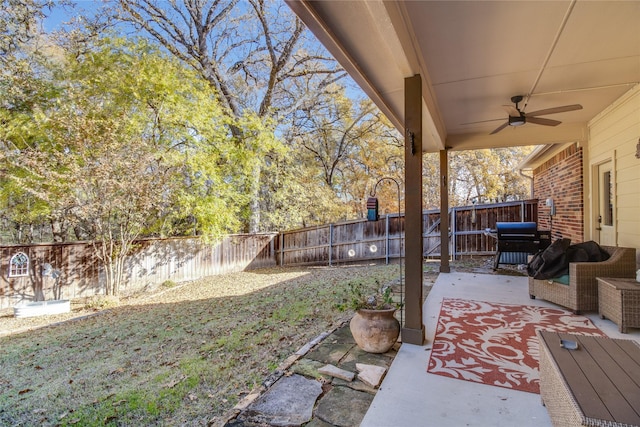 view of yard featuring an outdoor living space, a patio, and ceiling fan