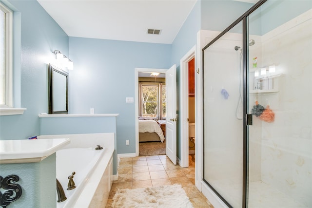 bathroom with tile patterned flooring and separate shower and tub