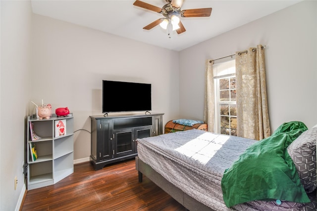 bedroom with dark hardwood / wood-style flooring and ceiling fan