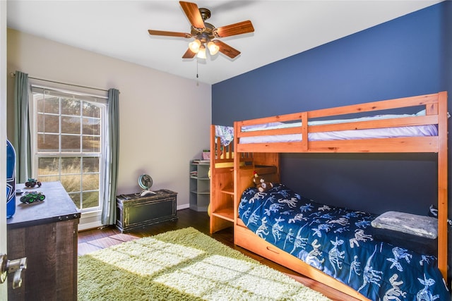 bedroom with ceiling fan and wood-type flooring