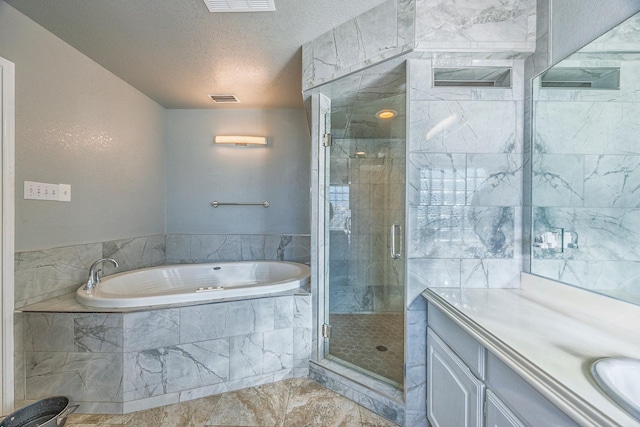 bathroom featuring vanity, a textured ceiling, and shower with separate bathtub