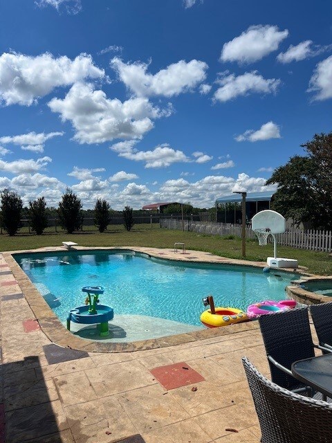 view of pool featuring a lawn, a diving board, and a patio