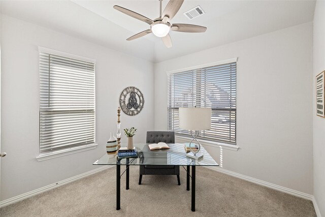 home office with ceiling fan and light colored carpet