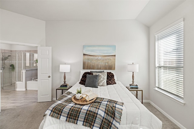 carpeted bedroom featuring lofted ceiling and multiple windows