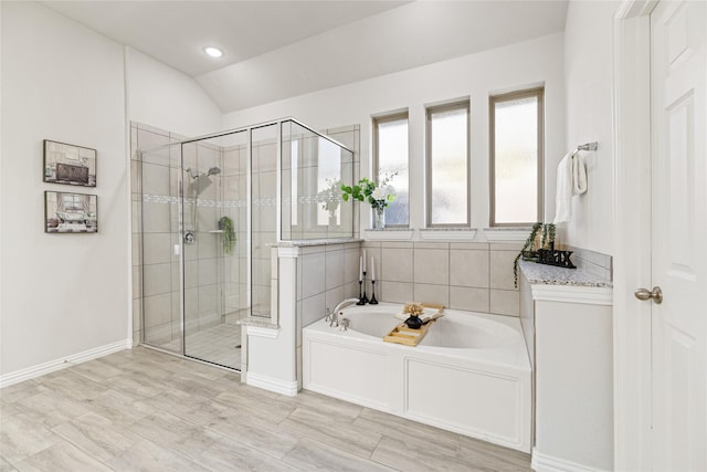 bathroom with lofted ceiling and independent shower and bath