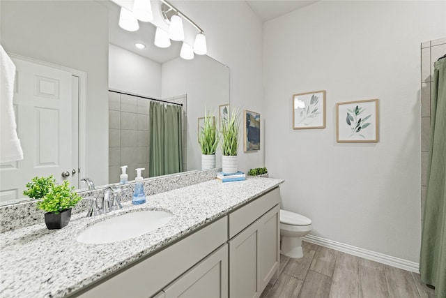 bathroom with vanity, hardwood / wood-style flooring, and toilet