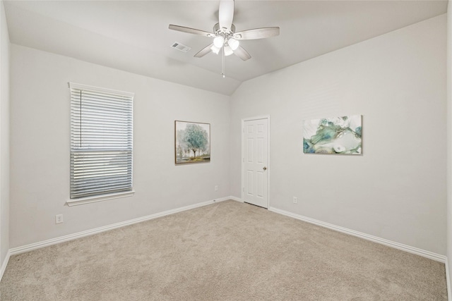 unfurnished room with light carpet, vaulted ceiling, and ceiling fan