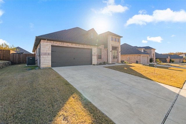 view of front of property with a front lawn, cooling unit, and a garage