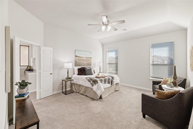 carpeted bedroom featuring multiple windows and ceiling fan