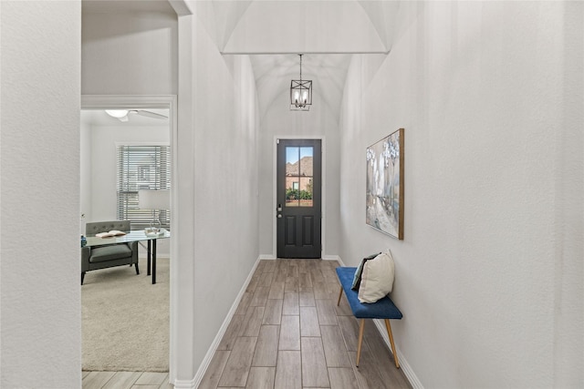 foyer with light hardwood / wood-style flooring, a wealth of natural light, and a notable chandelier