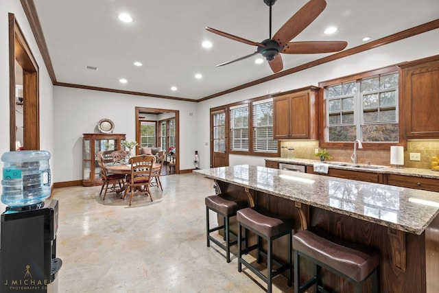 kitchen with a kitchen island, a breakfast bar, and backsplash