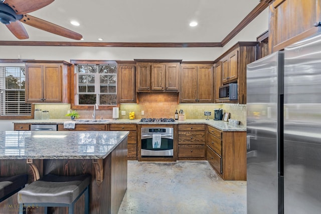 kitchen with appliances with stainless steel finishes, a breakfast bar, light stone countertops, and backsplash