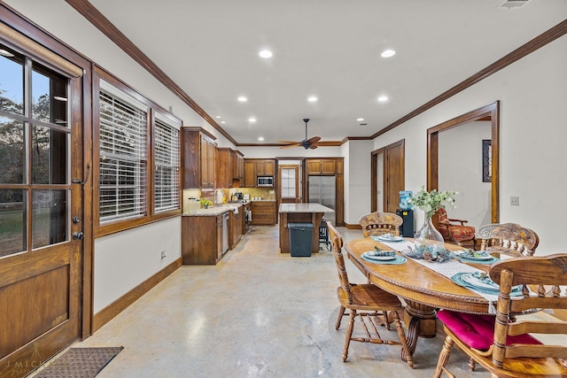 dining space featuring crown molding and ceiling fan