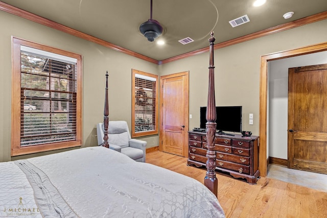 bedroom featuring multiple windows, ornamental molding, and light hardwood / wood-style flooring