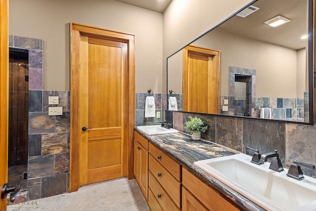 bathroom with tasteful backsplash, vanity, and tile walls