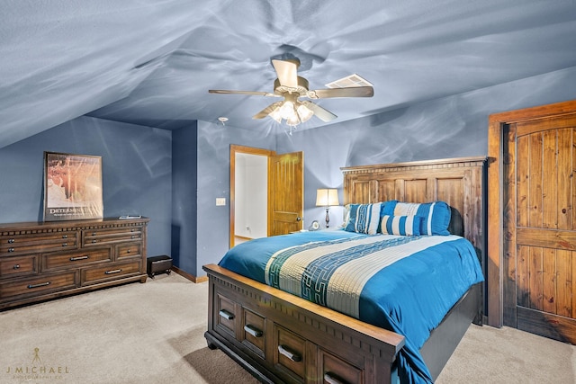 bedroom with ceiling fan, light colored carpet, and vaulted ceiling