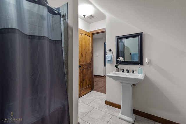 bathroom with tile patterned flooring and a shower with shower curtain