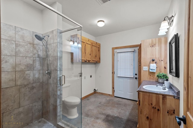 bathroom with vanity, concrete floors, an enclosed shower, and toilet