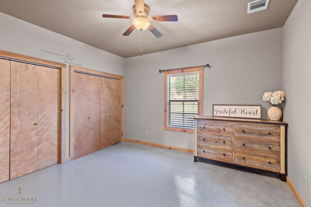 436 Goldsberry Cir, Shreveport, LA 71106 - bedroom with two closets, baseboards, visible vents, and ceiling fan