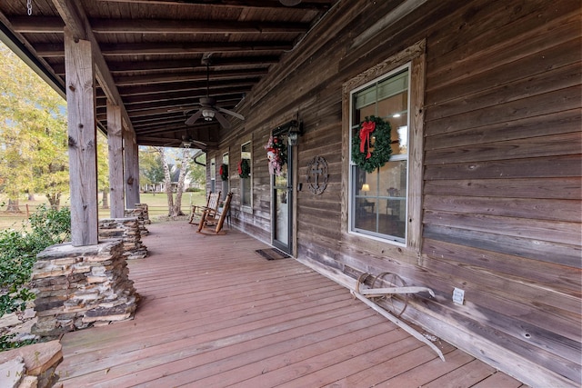 wooden terrace with ceiling fan and a porch