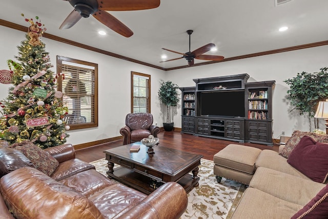 living room with wood-type flooring, ornamental molding, and ceiling fan