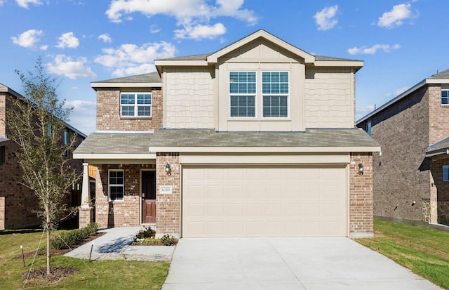 view of front of house with a garage and a front lawn