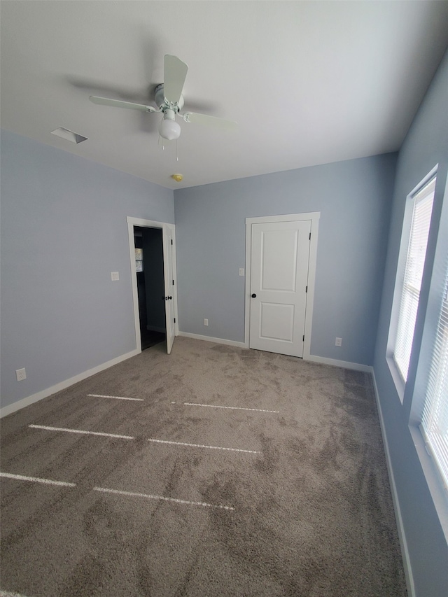 empty room featuring carpet floors and ceiling fan