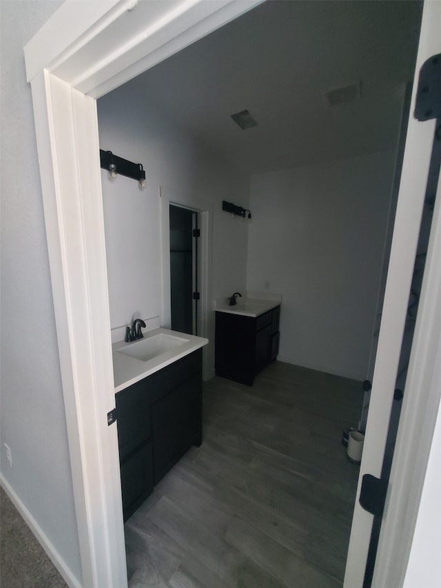 bathroom with vanity and hardwood / wood-style flooring