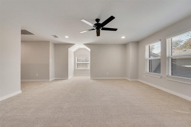 carpeted spare room with ceiling fan