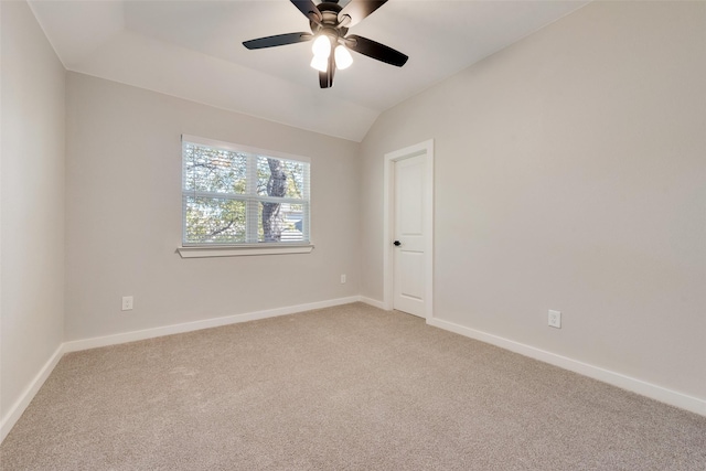 unfurnished room featuring light carpet, ceiling fan, lofted ceiling, and baseboards