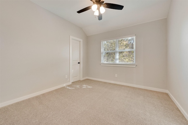 unfurnished room with lofted ceiling, light carpet, ceiling fan, and baseboards