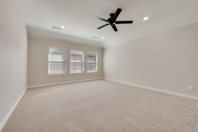 spare room with light carpet, baseboards, and recessed lighting